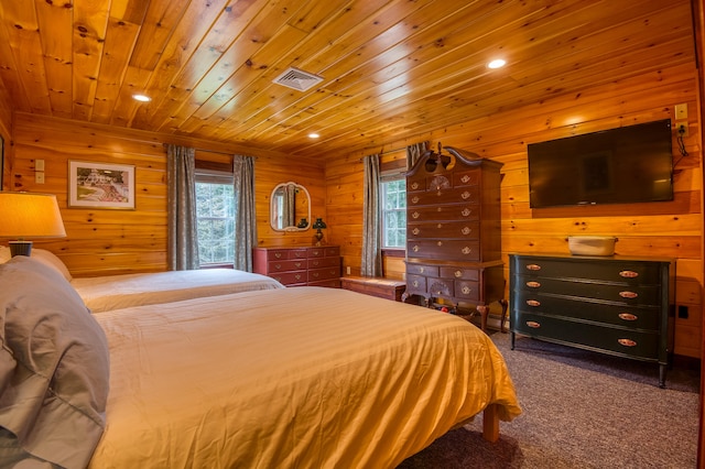 carpeted bedroom with wood ceiling and wooden walls