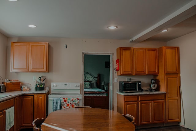 24 Elm St, Houlton, ME 04730 - kitchen featuring stainless steel microwave, electric stove, recessed lighting, dark wood-style floors, and brown cabinets