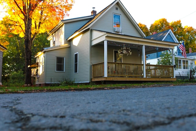 24 Elm St, Houlton, ME 04730 - view of front of house featuring a porch and a chimney