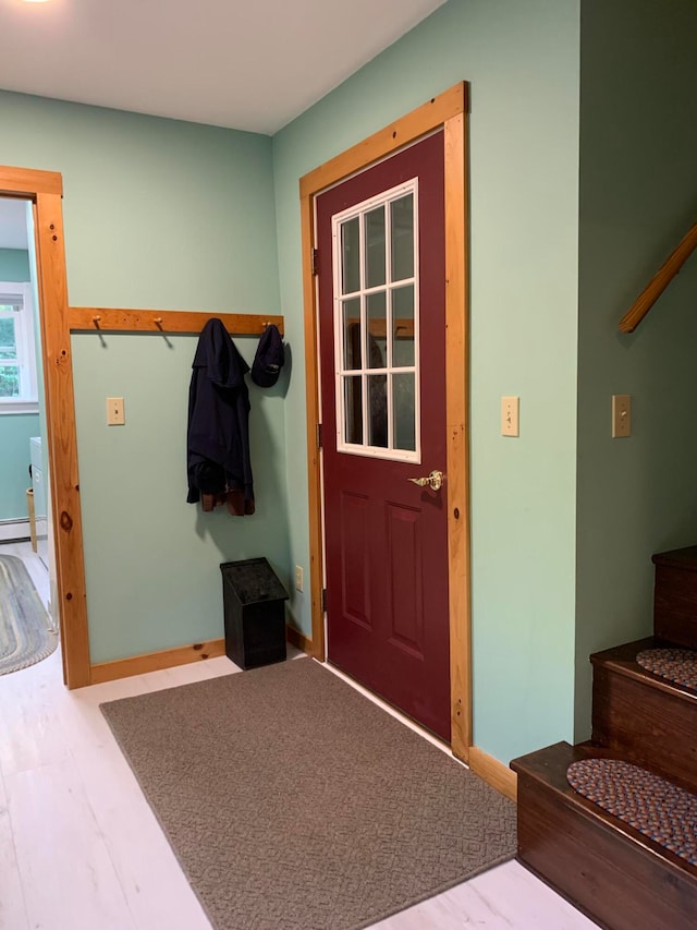 mudroom featuring wood-type flooring and a baseboard heating unit