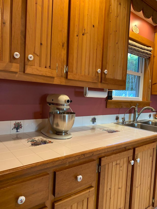 kitchen featuring tile counters and sink