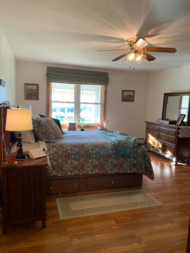 bedroom with ceiling fan and hardwood / wood-style flooring