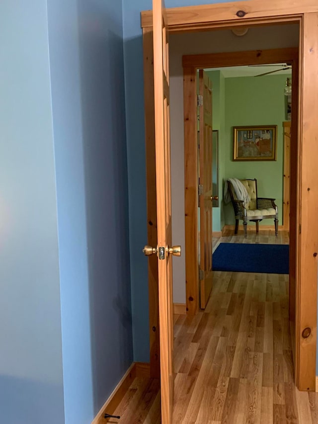 hallway with light hardwood / wood-style floors