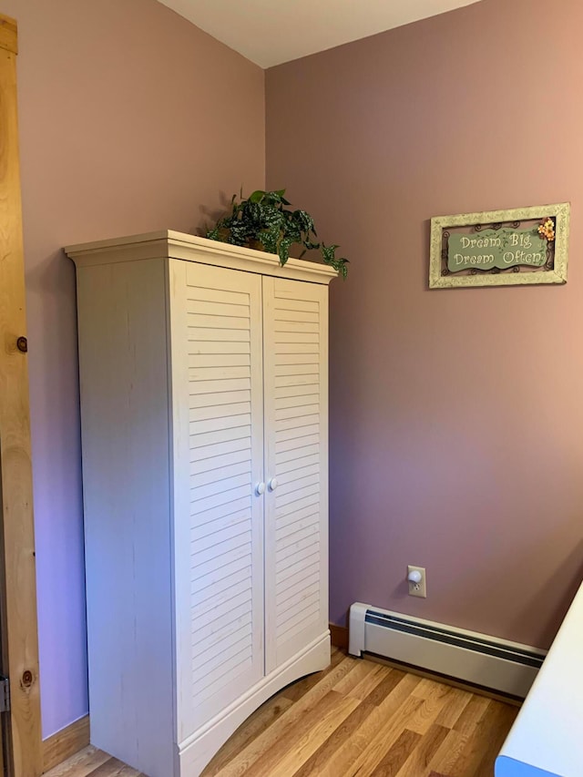 bedroom featuring light hardwood / wood-style flooring and a baseboard radiator