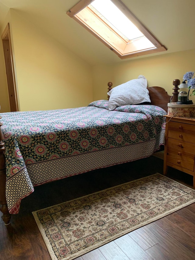 bedroom with wood-type flooring and lofted ceiling with skylight