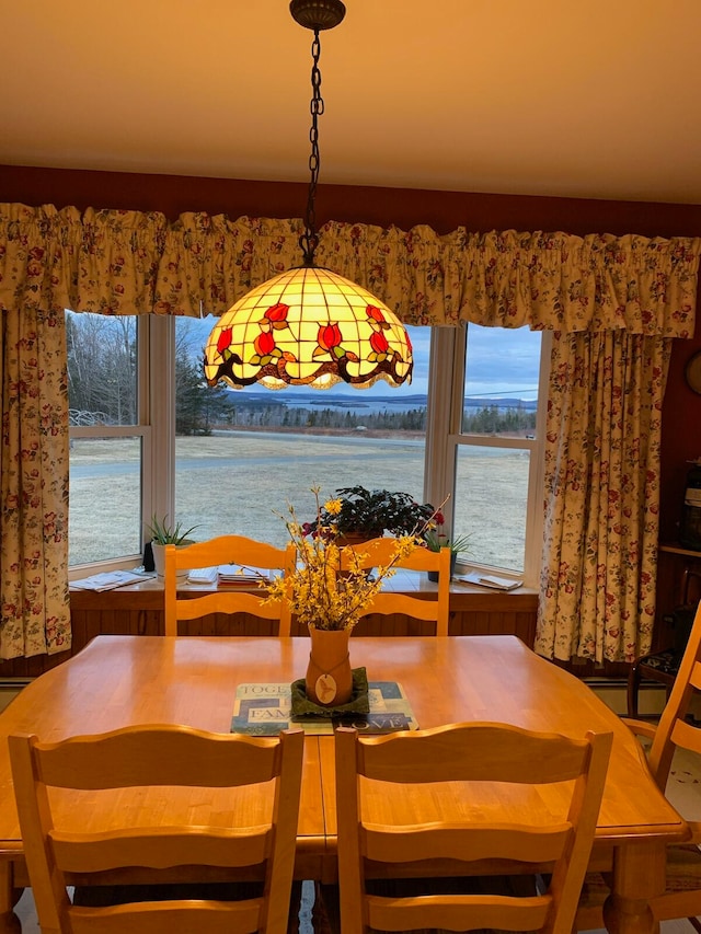 dining space featuring a water view