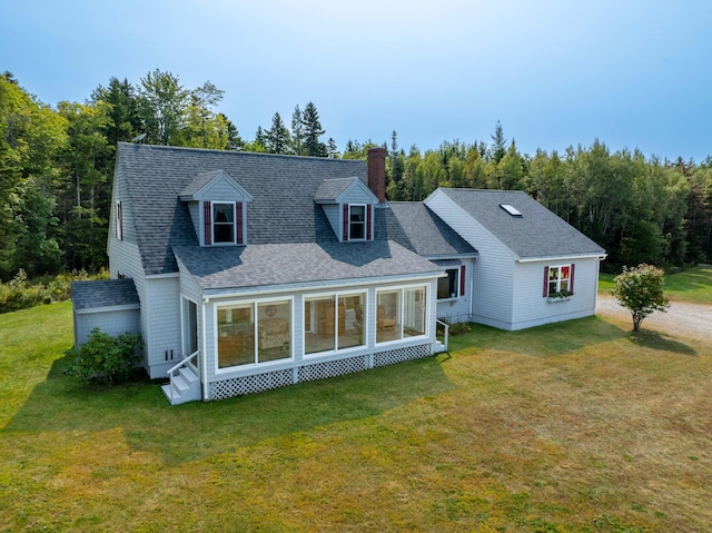 rear view of property featuring a yard