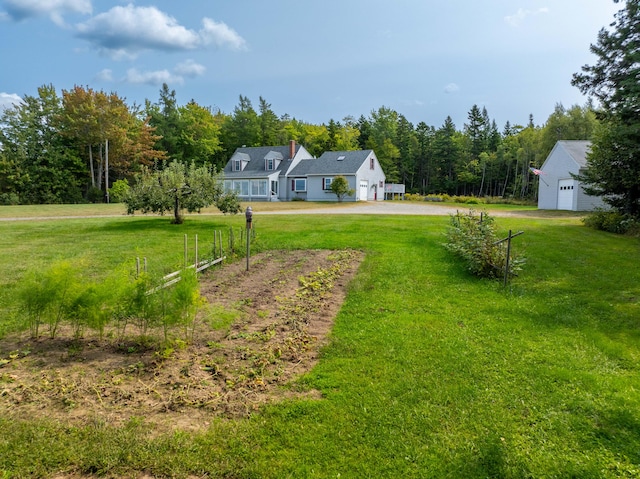 view of yard featuring an outbuilding and a garage