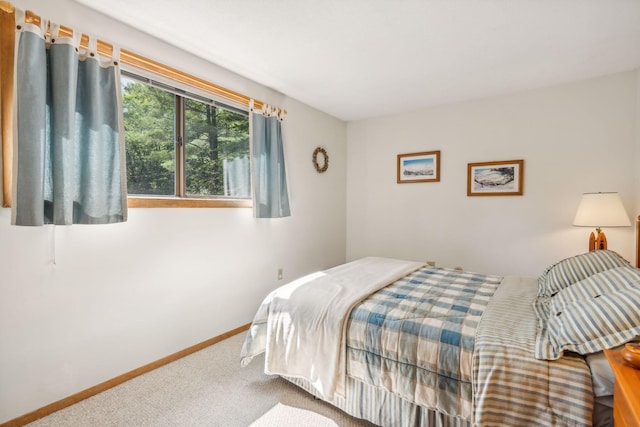 bedroom with carpet and baseboards