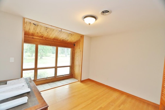 interior space featuring wood walls and hardwood / wood-style floors