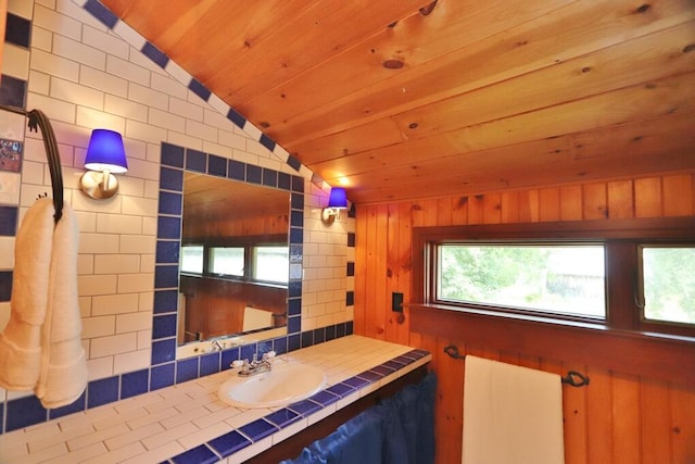 bathroom with vanity, wood ceiling, lofted ceiling, and wooden walls