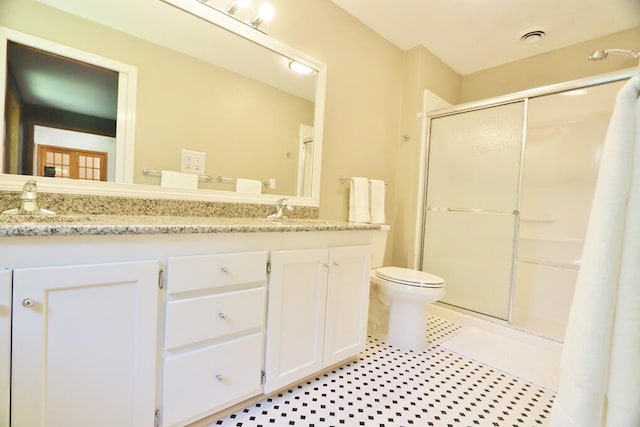 bathroom with vanity, toilet, and an enclosed shower