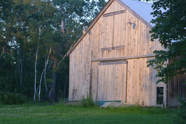 view of outbuilding featuring a lawn