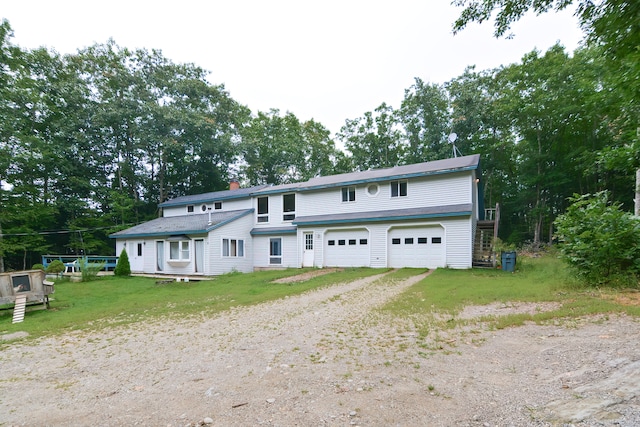 view of front of home with a garage and a front yard