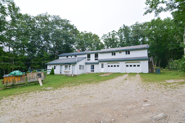 view of front facade featuring a front yard and a garage