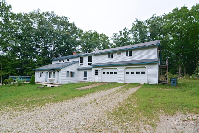 view of front of property with a garage and a front lawn