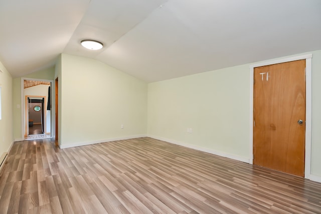 bonus room with vaulted ceiling and hardwood / wood-style floors