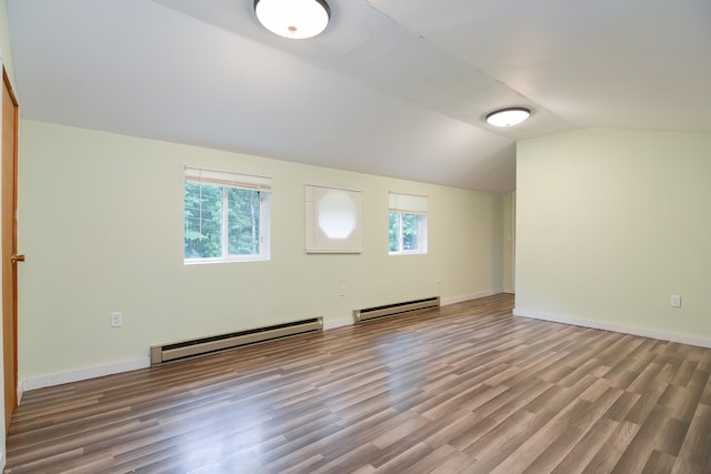 bonus room featuring a baseboard heating unit, wood-type flooring, and vaulted ceiling