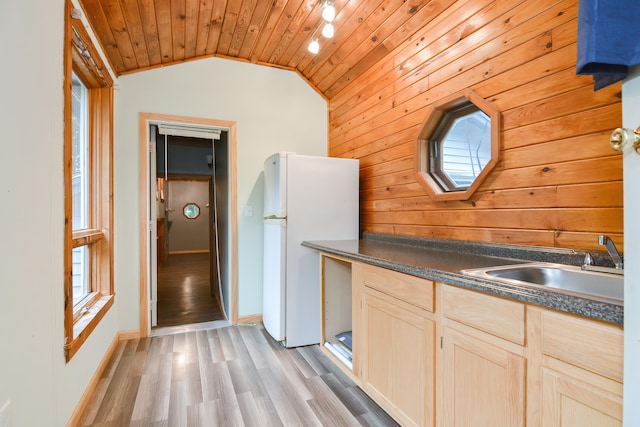 kitchen with light brown cabinetry, vaulted ceiling, light wood-type flooring, white refrigerator, and wood ceiling