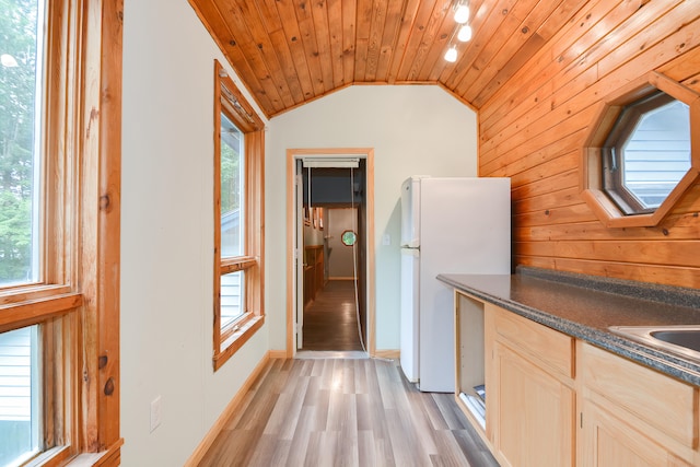 kitchen featuring light wood-type flooring, wood ceiling, light brown cabinetry, white refrigerator, and vaulted ceiling