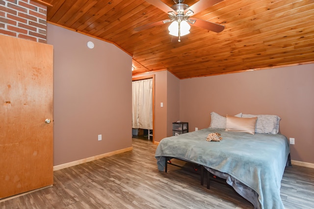 bedroom with lofted ceiling, ceiling fan, wood-type flooring, and wooden ceiling