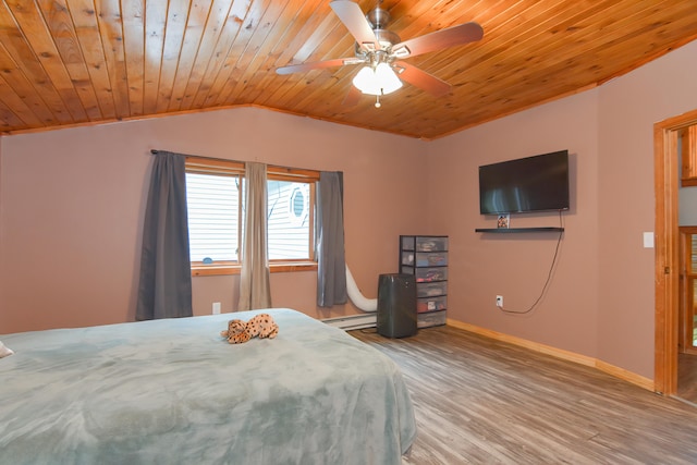 unfurnished bedroom with ceiling fan, a baseboard heating unit, wood ceiling, lofted ceiling, and hardwood / wood-style flooring