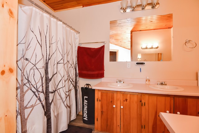 bathroom with vaulted ceiling, hardwood / wood-style floors, wood ceiling, a shower with curtain, and vanity