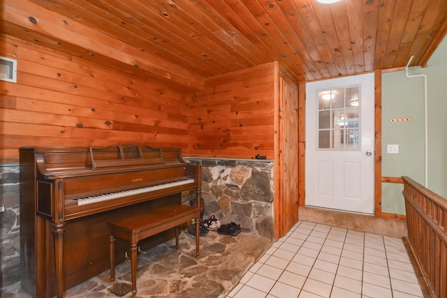 interior space with wooden ceiling, wooden walls, and tile patterned flooring