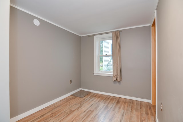 unfurnished room with ornamental molding and light hardwood / wood-style floors