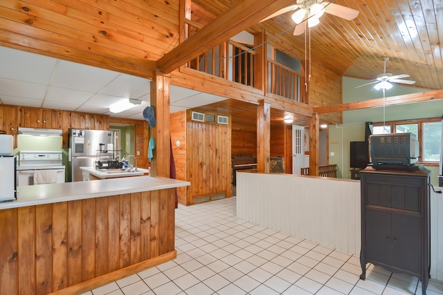 kitchen with ceiling fan, stove, stainless steel refrigerator, and light tile patterned flooring