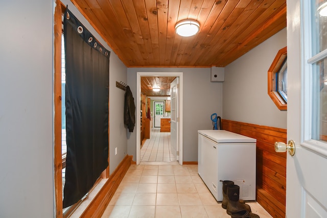 laundry room with wooden ceiling and light tile patterned floors