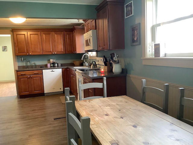 kitchen with white appliances, dark hardwood / wood-style flooring, and sink