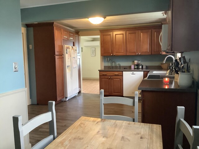 kitchen featuring white appliances, a wall mounted air conditioner, wood-type flooring, and sink