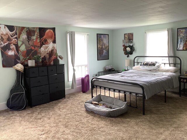 bedroom featuring light carpet