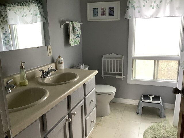 bathroom featuring vanity, toilet, and tile patterned flooring