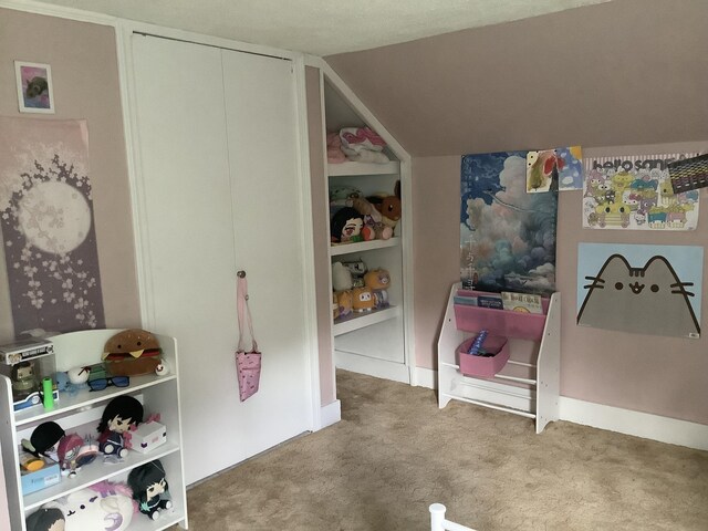 carpeted bedroom with vaulted ceiling