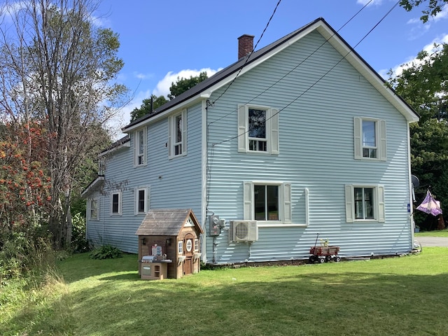 rear view of property featuring a lawn