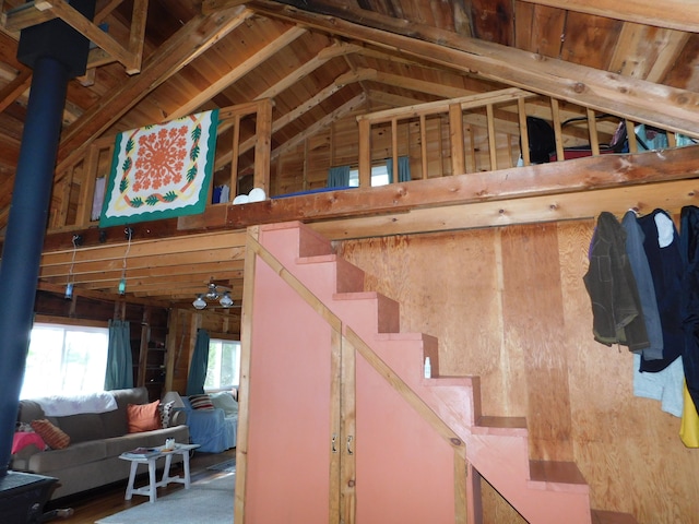 stairway featuring wood-type flooring and vaulted ceiling