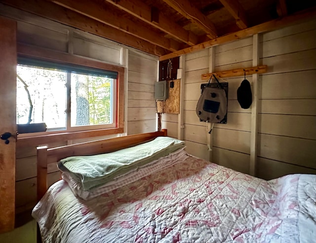 bedroom featuring wood walls