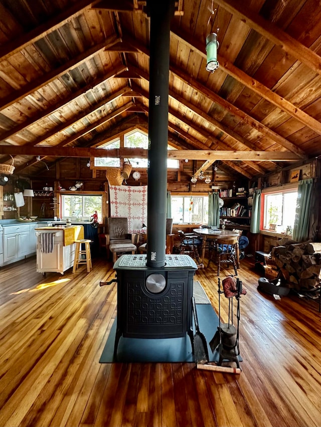 living room featuring wood ceiling, plenty of natural light, light hardwood / wood-style floors, and lofted ceiling with beams