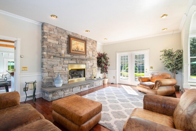 living room featuring a fireplace, dark wood-type flooring, and ornamental molding