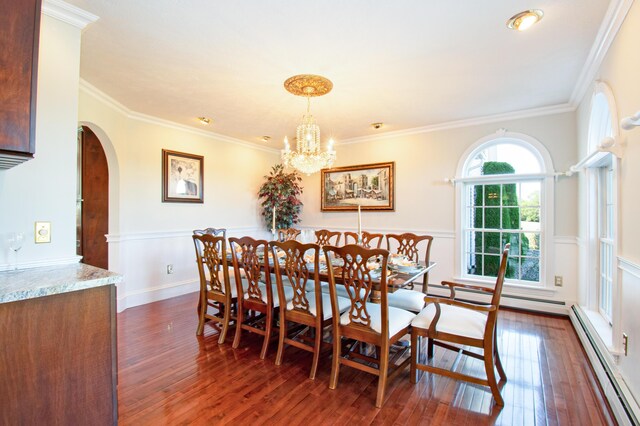 dining room with a baseboard heating unit, a chandelier, dark hardwood / wood-style flooring, and ornamental molding