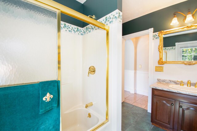 bathroom with tile patterned floors, enclosed tub / shower combo, and vanity