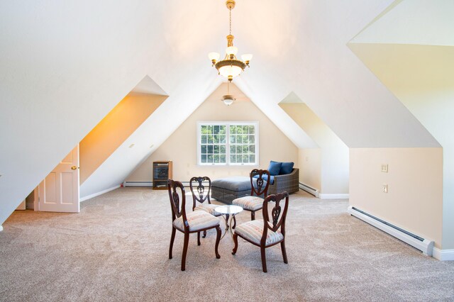 interior space featuring lofted ceiling, baseboard heating, and a notable chandelier