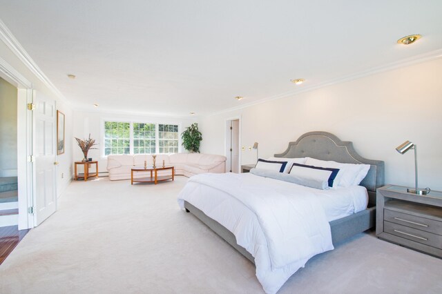 bedroom with light colored carpet and ornamental molding