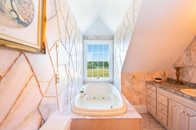 bathroom featuring tile patterned floors, vaulted ceiling, tile walls, tiled bath, and vanity