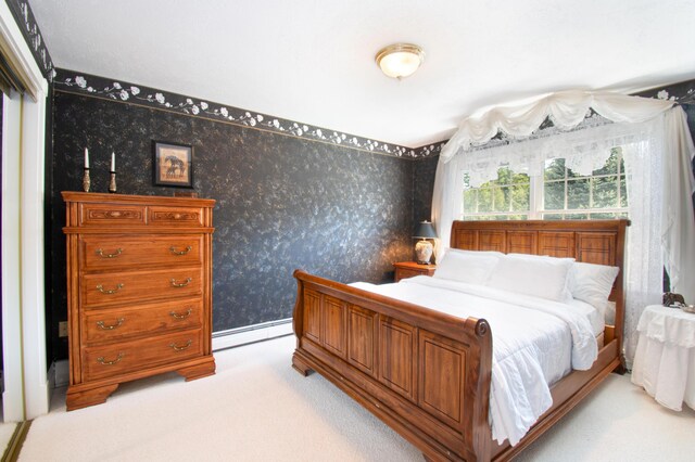 carpeted bedroom featuring a baseboard radiator