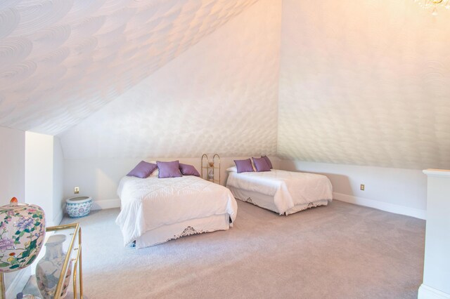 carpeted bedroom with vaulted ceiling