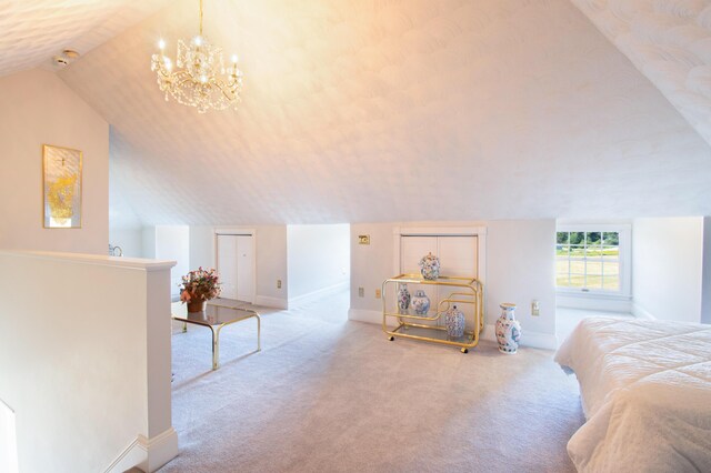 bedroom featuring light colored carpet, vaulted ceiling, and a chandelier