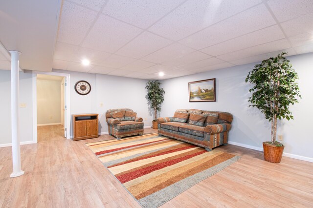 living room with hardwood / wood-style flooring and a drop ceiling